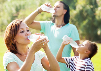 family-drinking-bottled-spring-water